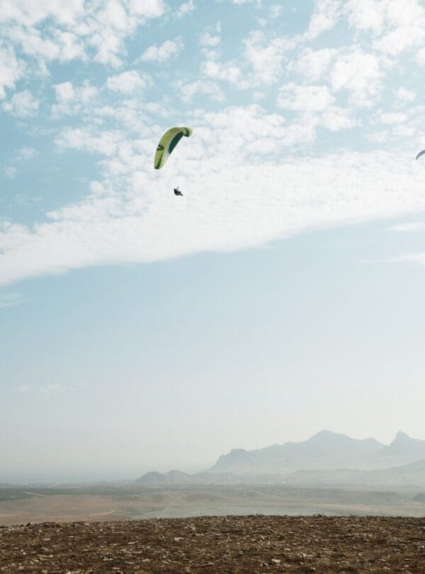 young-blonde-woman-sitting-top-hill_273609-15319